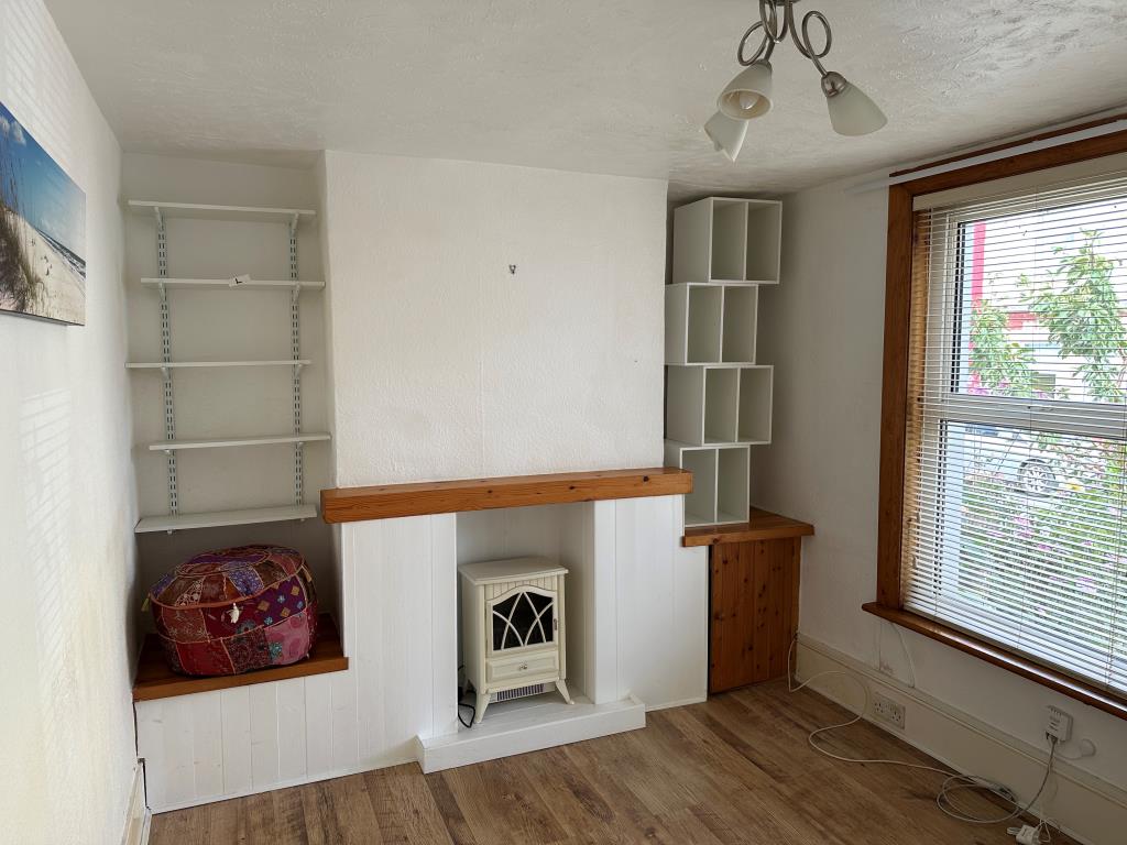 Lot: 77 - TWO-BEDROOM TERRACED HOUSE FOR REFURBISHMENT - Living Room with window overlooking front garden